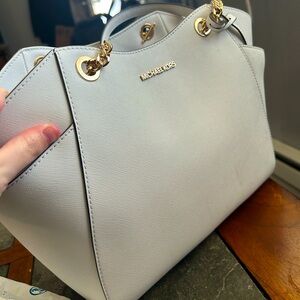 I am selling my Michael Kors purse is white and it is in good condition.